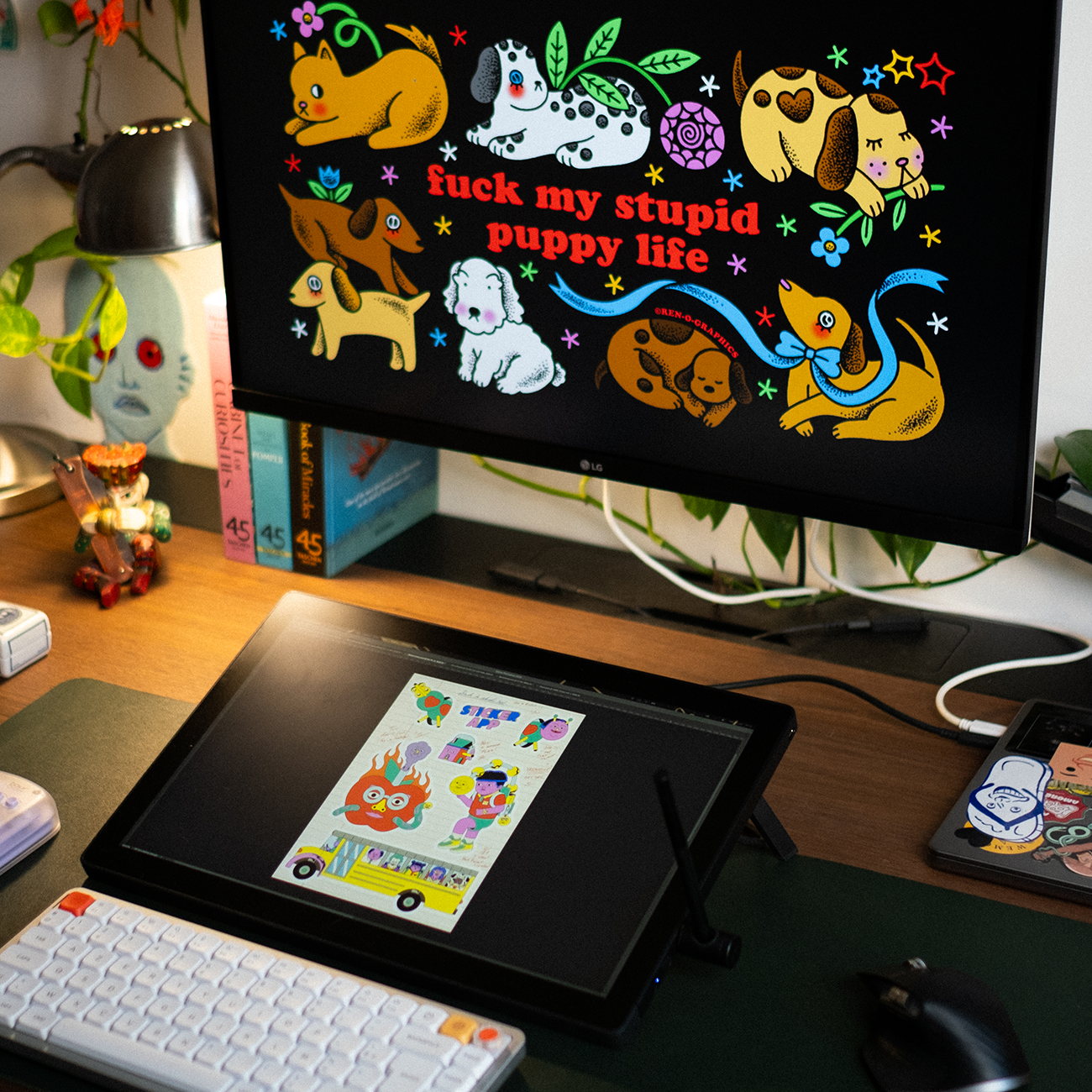 laptop and screen with colorful artwork in a studio environment, with the text "FUCK MY STUPID PUPPY LIFE" showing on the screen