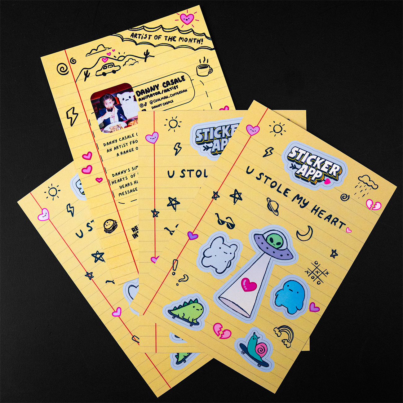 Yellow sheets with playful sticker designs, including aliens, hearts, and doodles, and a section featuring "Artist of the Month: Danny Casale."