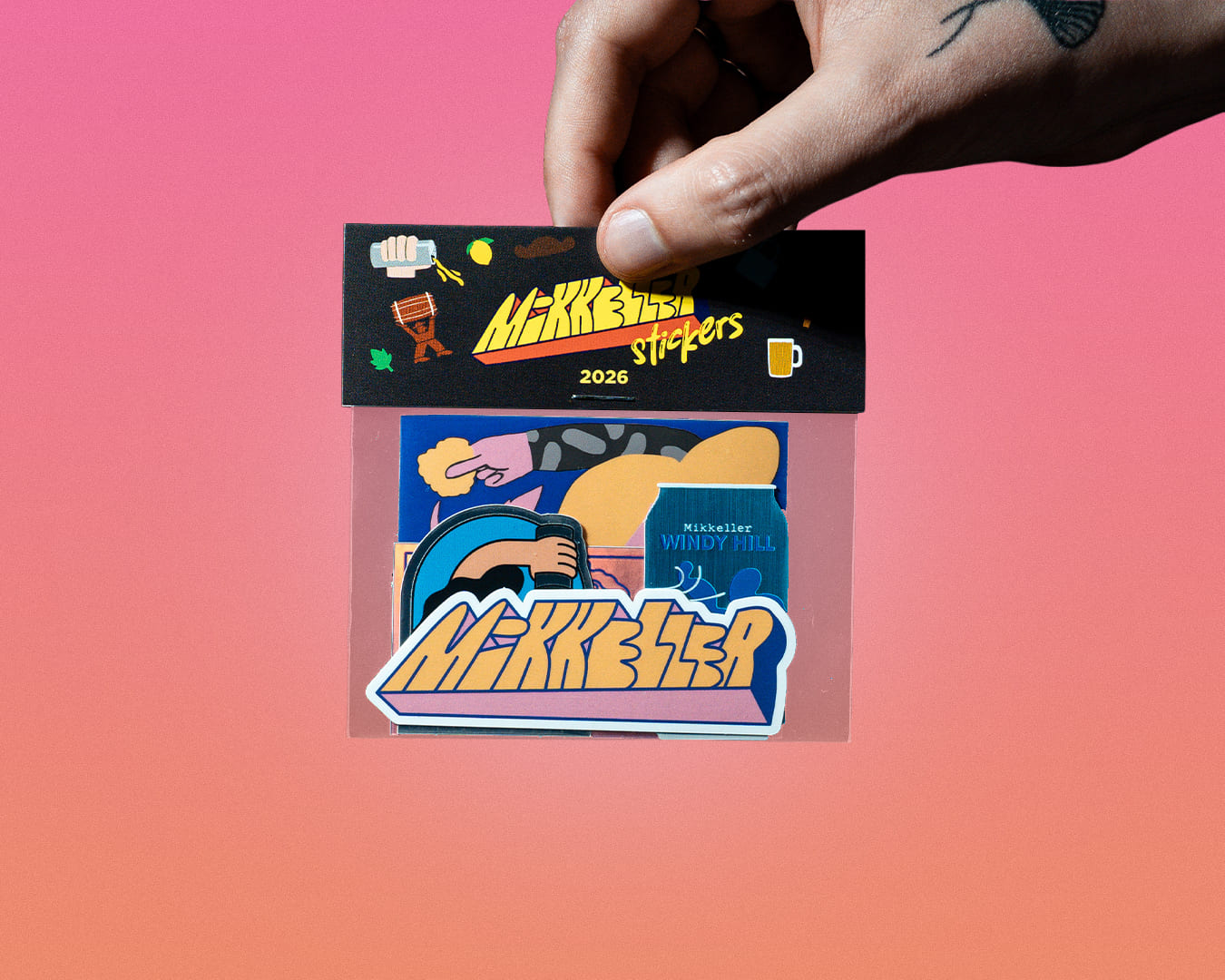 A hand holding a stickerpack