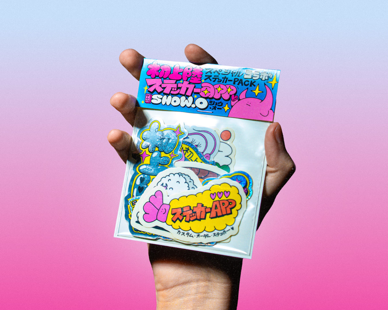 A hand holding a stickerpack